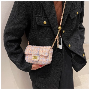 Detail of adjustable gold ball slider on a pink tweed mini crossbody bag chain