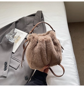 Detail of khaki plush bucket bag showing soft faux fur texture and leather drawstring