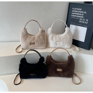 Detail of plush tote bags in beige, white, black, and brown with leather handles and tags