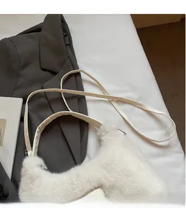 Detail of white plush shoulder bag with smooth long leather strap and soft texture