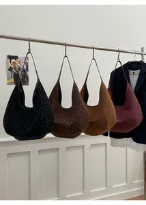 Detail view of four large hobo tote bags with leopard embossing in dark fall colors