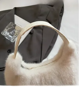 Detail of plush off-white handbag with silver zipper and smooth top handles