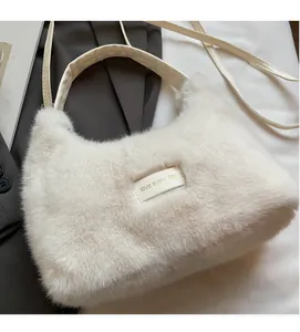 Close-up of white plush handbag with 'Love Every Day' leather patch and soft texture