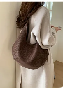 Macro detail of brown leopard print hobo bag showing soft matte texture and large size