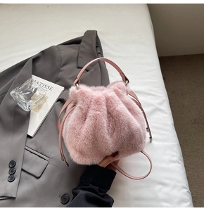 Detailed top view of pink plush bucket bag with drawstring closure and soft fur texture