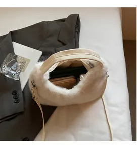Spacious interior of white faux fur crossbody bag showing room for wallet and essentials