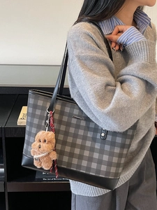 Classic checkered tote bag in charcoal grey with a brown poodle plush charm on shoulder