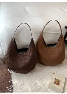 Detail view of leopard print hobo bucket bags in matte finish for autumn style