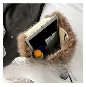 Detail view of brown plush backpack showing large capacity for tablet and phone