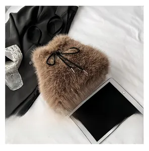 Detailed close-up of brown faux fur backpack featuring a black leather drawstring closure