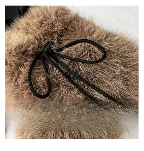 Detail of plush faux fur texture with black nylon drawstring and metal hardware