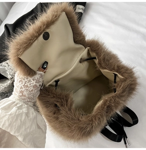 Detail showing the soft brown faux fur texture and magnetic clasp of the plush backpack