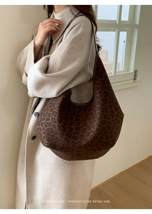 Close-up of leopard print tote bag styled with a beige trench coat for a retro vibe