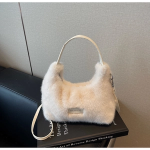 Close-up of white plush handbag with PU leather handles and 'love every day' patch