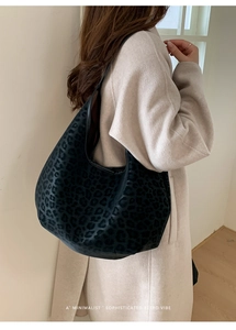 Close-up of leopard print hobo bag showing its large capacity and soft texture on model