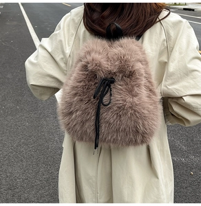 Detailed back view of a fuzzy brown faux fur backpack with a black drawstring closure