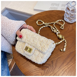 Detailed close-up of ivory tweed mini crossbody bag with golden chain and bead strap