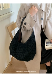 Detail of grey leopard print tote bag with soft suede texture and leather shoulder strap