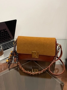 Vintage brown leather crossbody bag with gold F-buckle and beaded tassel detail