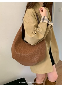 Close-up of brown leopard print hobo bag with a minimalist sophisticated retro vibe