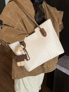 Retro white woven tote bag with brown leather straps and a cute teddy bear charm