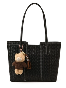 Black woven leather tote bag with stylish white stitching and a cute teddy bear charm