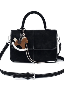 Black leather crossbody bag with white contrast stitching and wooden horse pendant