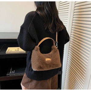 Brown plush handbag with leather strap shown in a cozy autumn lifestyle setting