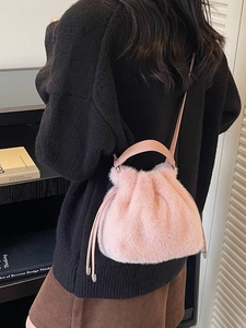 Pink faux fur drawstring bucket bag with plush handle and slim shoulder strap for women