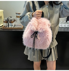 Detail of pink faux fur backpack featuring black drawstring closure and nylon straps