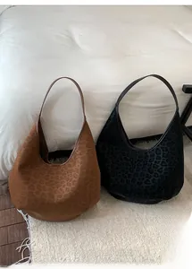 Close-up of leopard print hobo tote bags in brown and black suede finish