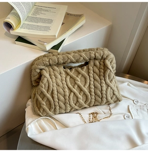 Detail of khaki cable knit texture and golden chain strap on a soft winter handbag