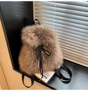 Detail of plush faux fur backpack showing fluffy texture and black drawstring closure