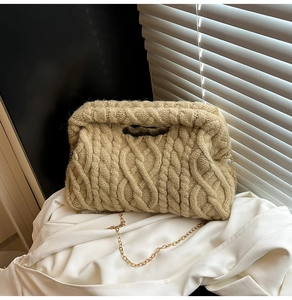 Close-up of beige chunky cable knit handbag with premium gold chain strap detail