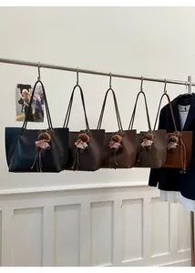 Detail of high-quality large tote bags in five vintage colors with cute bear pendants