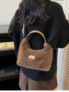 Plush brown teddy bear handbag with leather handles and metallic adjustable shoulder strap