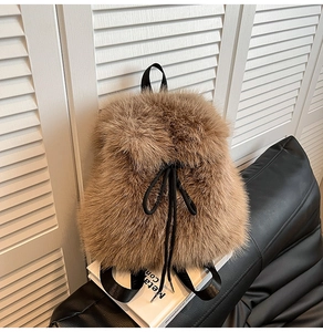 Detail of fluffy brown faux fur backpack with drawstring closure and woven straps