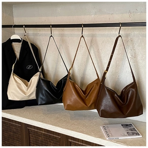 Detailed row of minimalist soft leather tote bags in four colors with adjustable buckles