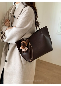 Brown tote bag in lychee texture grain leather with cute teddy bear charm on shoulder