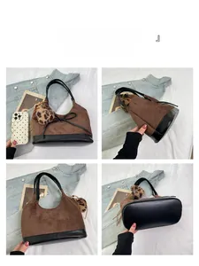 Detail view of brown suede bucket bag with black leather base and leopard print pompom