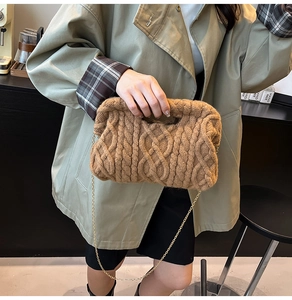 Macro shot of brown cable-knit texture and gold chain strap on stylish shoulder bag