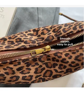 Detail showing the smooth metal zipper on the leopard print tote bag with soft texture