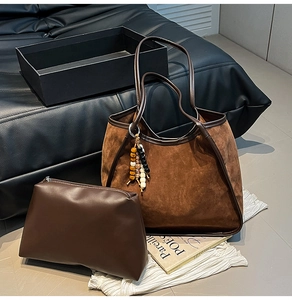 Detail of suede leopard-print tote bag set with beaded pendant and matching leather pouch