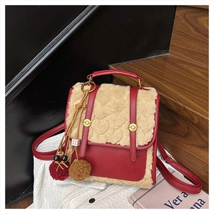 Close-up of stylish mini backpack with red faux leather and beige plush faux fur details