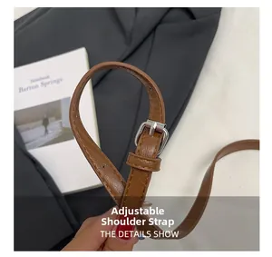 Macro detail of brown litchi pattern leather adjustable strap with silver metal buckle