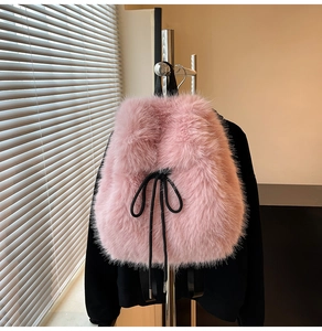 Close-up of pink faux fur backpack featuring soft plush texture and black drawstring closure