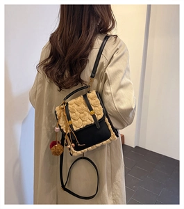 Detail of small vintage chic backpack showing heart-embossed plush and leather textures