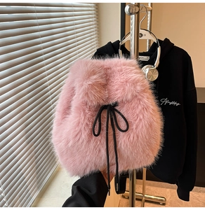 Detail of pink faux fur backpack with black drawstring closure and soft plush texture
