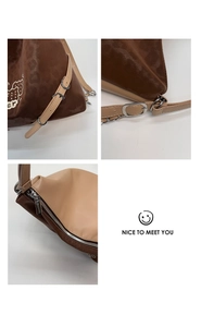 Detailed macro view of dual-tone faux leather texture and silver hardware zipper on tote