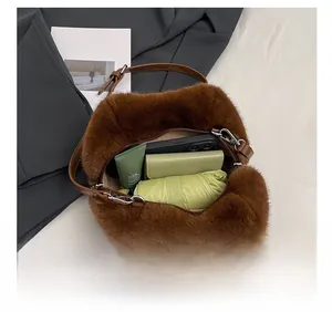 Top view of brown faux fur tote bag showing interior space with a phone, wallet and umbrella